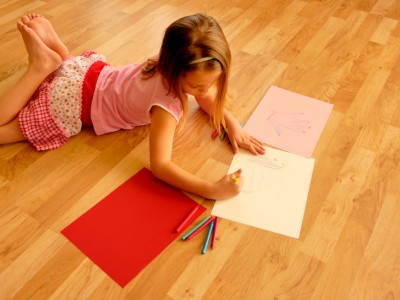 Little girl coloring on hardwood floor, how to clean a hardwood floor