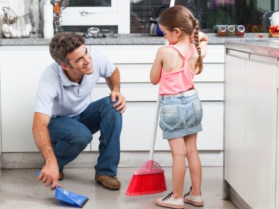 E&B Carpet Dad and daughter in kitchen cleaning up mess.