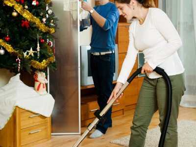 E&B Carpet woman vacuuming and man cleaning a window