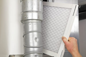 image of a person installing a home air filter