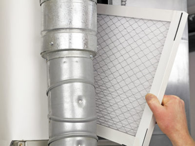image of a person installing a home air filter